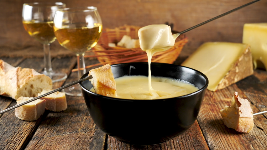 Cheese fondue with bread and wine- french winter dish | Shutterstock HD Video #1059059015