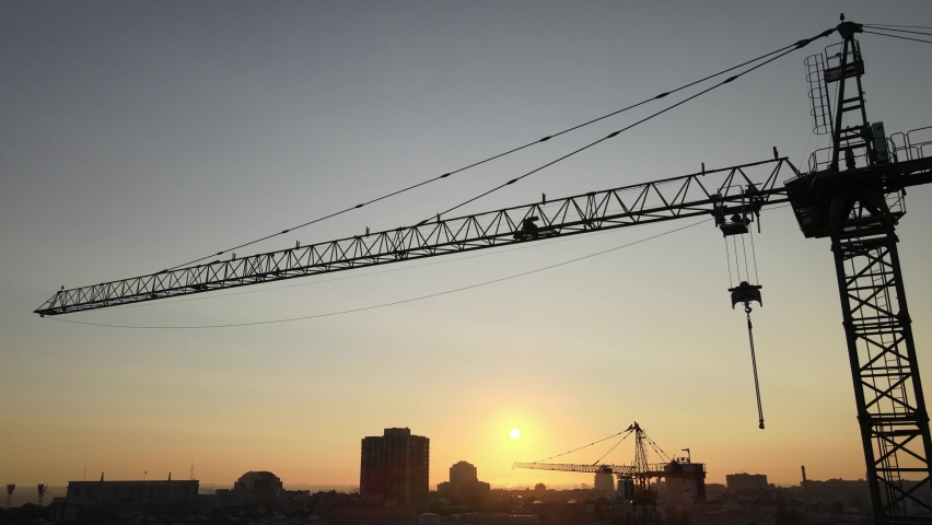 Construction crane on a construction site in the city at sunrise. Kyiv, Ukraine. Aerial view Royalty-Free Stock Footage #1059059837