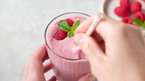 Raspberry smoothie in a glass. Fresh pink berry vegetarian smoothie
