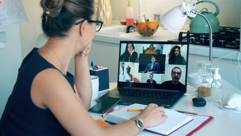 A lady is greeting her colleagues during a video conference call. Meeting online, remote work using videocall.