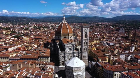 Drone spinning around Cathedral of Santa Maria del Fiore and city on a sunny day in Florence in Italy in 4k.