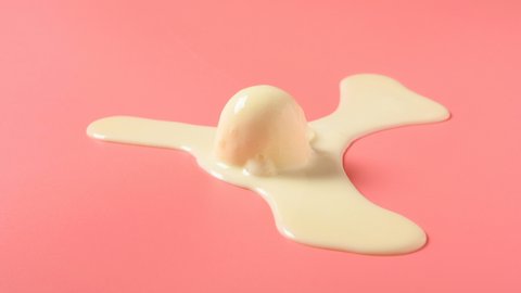 side view vanilla flavor ice cream ball melting timelapse on a pink background at 8K resolution