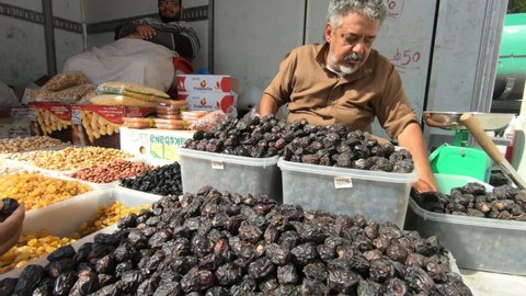Arabian old man selling dry dates at flea market, Mecca, Saudi Arabia, 27 December 2019 