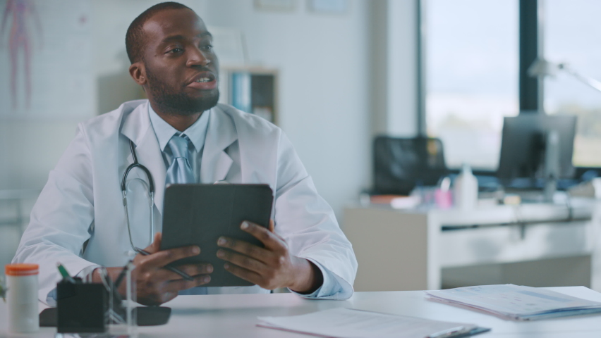 Young Black Medical Doctor Showing Mammography Test Results to a Patient on a Tablet Computer in a Health Clinic. Friendly Assistant Explains Importance of Breast Cancer Prevention Screening. | Shutterstock HD Video #1059073913