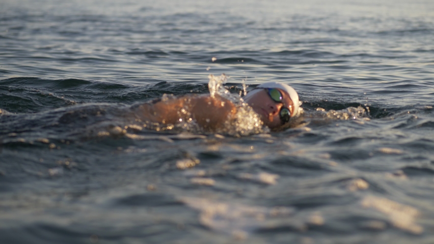 Professional Swimming Workout at Sunset, two athletes Swimming Preparing for Competition. Professional Swimmer Workout In Open Water. Swimmer Sport Exercising. High quality 4k footage Royalty-Free Stock Footage #1059080621