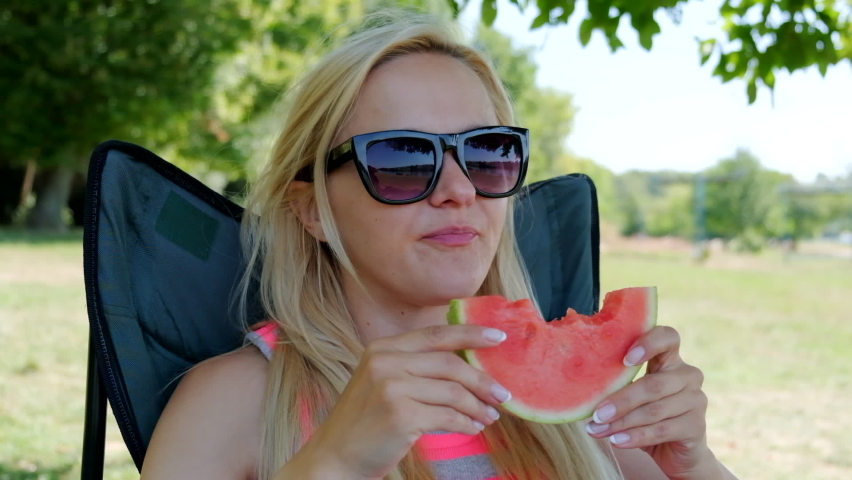 Young woman eating watermelon. Close-up. Slow motion.