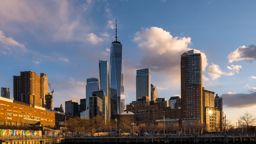 New York City - USA - Mar 19 2019: Day to Night Timelapse Sunset Clouds Moving Over One World Trade Center POV view from Pier 25 in TriBeCa District Royalty-Free Stock Footage #1059082313