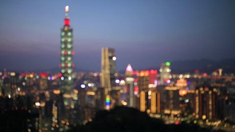 View from above, defocused video of the Taipei City skyline illuminated during a beautiful sunset. Panoramic view from the Mount Elephant in Taipei, Taiwan.