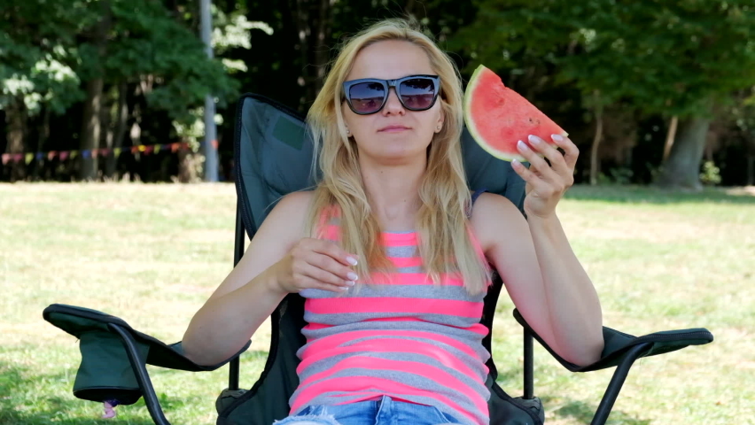 Young woman eating watermelon. Slow motion.