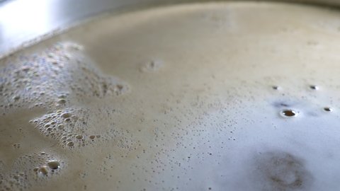 close up of beer being brewed in a saucepan. home brewing process.