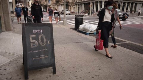New York / USA - Sept 14, 2020: 50% Discount sign in front of a store on Broadway in Soho New York. This area usually filled with people is nearly empty now. Filmed during Coronavirus Pandemic.