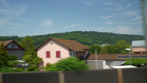BASEL, SWITZERLAND - JULY 9 2019: zurich to basel district sunny day train road trip passenger side pov panorama 4k circa july 9 2019 basel, switzerland.