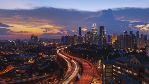 Kuala Lumpur Time Lapse: Sunset of cityscape during a golden sunset overlooking an elevated highway in Kuala Lumpur city. Malaysia. Cinematic. Prores 4KUHD