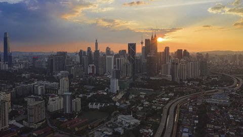 Kuala Lumpur Time Lapse: Sunset of cityscape during a golden sunset overlooking an elevated highway in Kuala Lumpur city. Malaysia. Cinematic. Prores Full HD