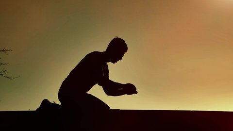 Religious man bows on sunset