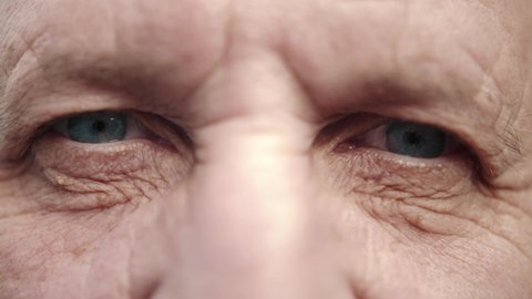 Face and eyes of mature person. Close up of large wrinkles on the face of senior male. Portrait of attractive elderly man. Doctor man face.