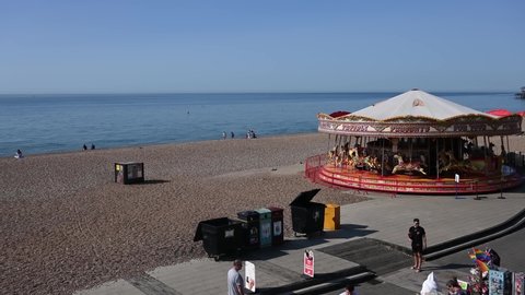 Brighton, East Sussex, UK, September 14, 2020. Brighton Beach with tourists enjoying the attractions like the carousel as they walk past the boat museum and cafes and restaurants. 