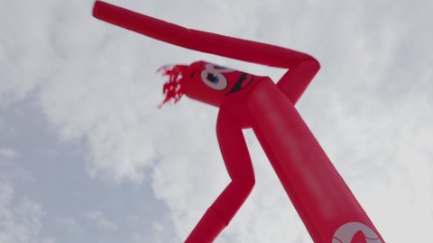 Air moving man - street advertising, Inflatable red sky dancer figure dancing.