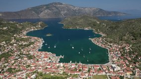Aerial drone rotational video of picturesque village capital and port of Ithaki or Ithaca island called Vathi a safe anchoring for sail boats, Ionian, Greece