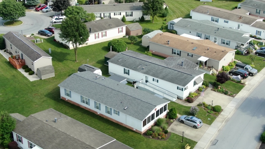 Aerial of mobile homes, trailer park, housing tightly compact, aerial drone view, establishing shot of residences in United States of America, USA during summer, low-income manufactured homes Royalty-Free Stock Footage #1059130604