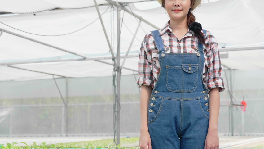 Happy smiling Asian woman farmer in the farmhouse. Concept small business vegetables