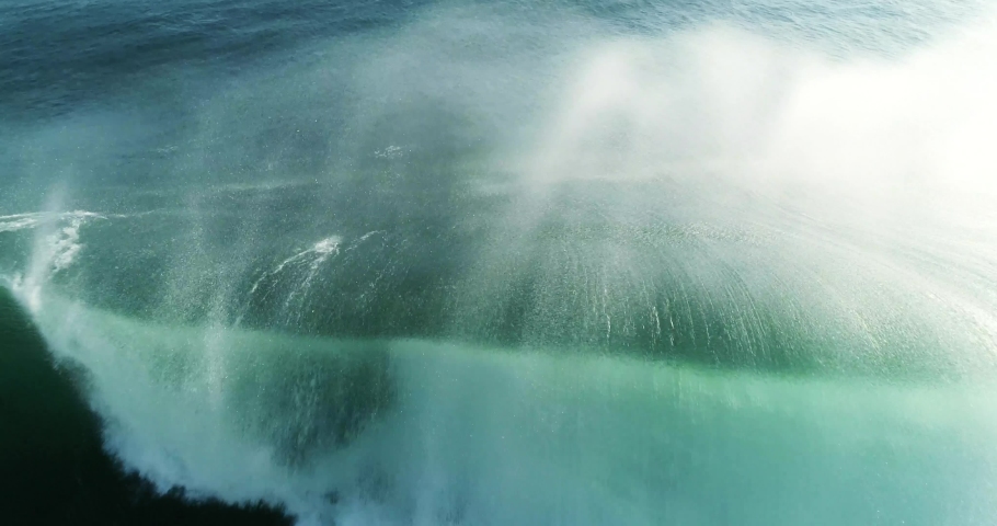 Aerial backwards follow shot rolling and breaking big powerful wave. 4K | Shutterstock HD Video #1059156158