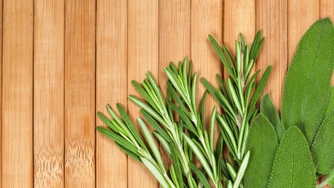 Collection of fresh herbs for cooking isolated on wood background. Bunch of herbs