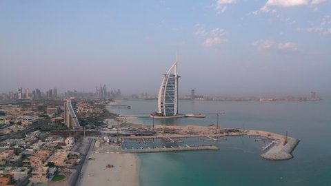 Amazing aerial view of Dubai beach side with Burj Al Arab hotel and Jumeirah Beach Hotel with Palm Jumeirah man made islands and Dubai Marina in background. - Dubai, UAE - Aug 2020