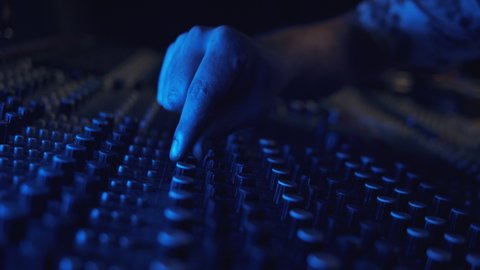 Music and sound studio. Male producer and dj. Close up of hands. Man working in the recording studio. brunette male person produces songs in headphones. 