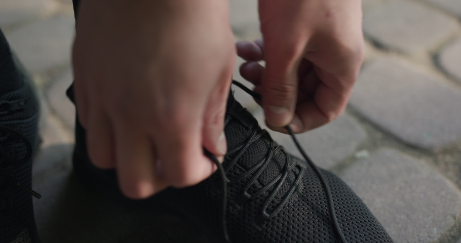 Closeup of feet runner getting ready tying running shoes Before Jogging Workout. Triathlon Runner Prepare Footwear Before Marathon Running. Tying Shoelace On Sport Shoes Outdoors. Royalty-Free Stock Footage #1059158945