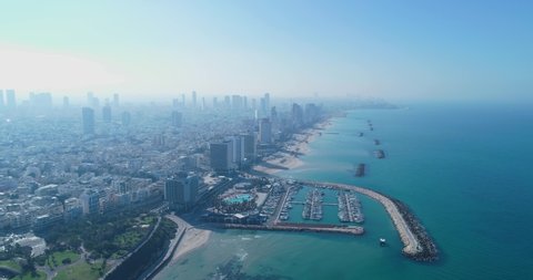 Israel skyline from a drone. Panoramic Aerial view above coastline of Tel Aviv modern and business city with hotels, seashore and beach. Middle east skylines