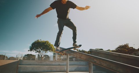 Skateboarder grinding rail in the park