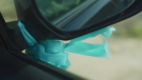 Beautiful ribbon tied to the side mirror of the car - Powered by Shutterstock - Get 15% off with code: PIKWIZARD15