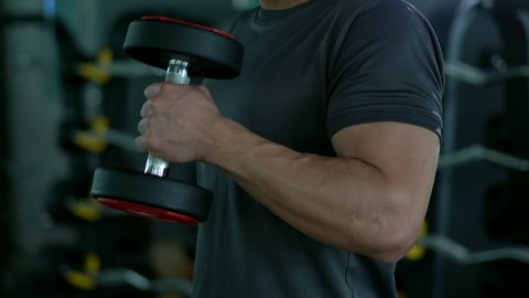 4K footage showing an unrecognizable people workout in the indoor gym, man lifting up a Hammer Curl weight exercise. Physical and muscle weight training  for body building workout.