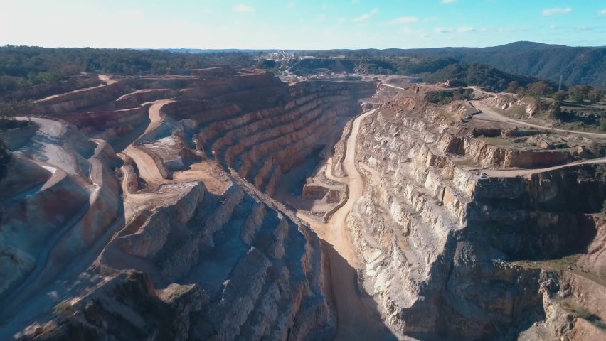 Aerial view of the canyon-like mine, Marulan South Limestone Mine, Peppertree Quarry, Australia. Royalty-Free Stock Footage #1059176777
