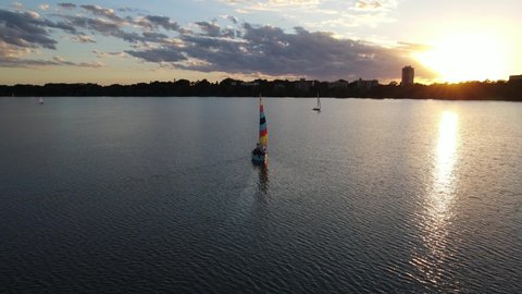 beautiful sunset at the lake with a boat sailing