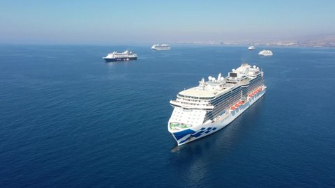 Six empty cruise ships are staying near the coast of Cyprus. They are isolated ships
