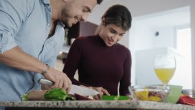 Young couple cooking food together at home with new recipe. Happy man and woman preparing omelette for lunch. Husband and wife smiling in kitchen. Married partners and lifestyle - Powered by Shutterstock - Get 15% off with code: PIKWIZARD15