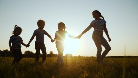 happy family children kid together walk in the park at sunset silhouette. people in the park dream concept. brother sister joyful walk hold hands. little baby fun child summer kid dream concept