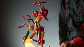 Super slow motion of flying chilli peppers from wok pan, chef closeup. Filmed on very high speed cinema camera, 1000 fps. - Powered by Shutterstock - Get 15% off with code: PIKWIZARD15