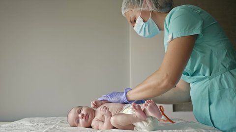 Pediatrician vaccinates the newborn in the clinic.