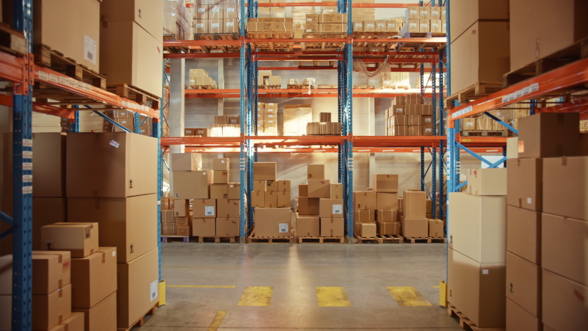Big Retail Warehouse full of Shelves with Goods in Cardboard Boxes and Packages. Logistics, Sorting and Distribution Facility for Product Delivery. High Moving Backward Between Rows of Shelves Camera Royalty-Free Stock Footage #1059197549