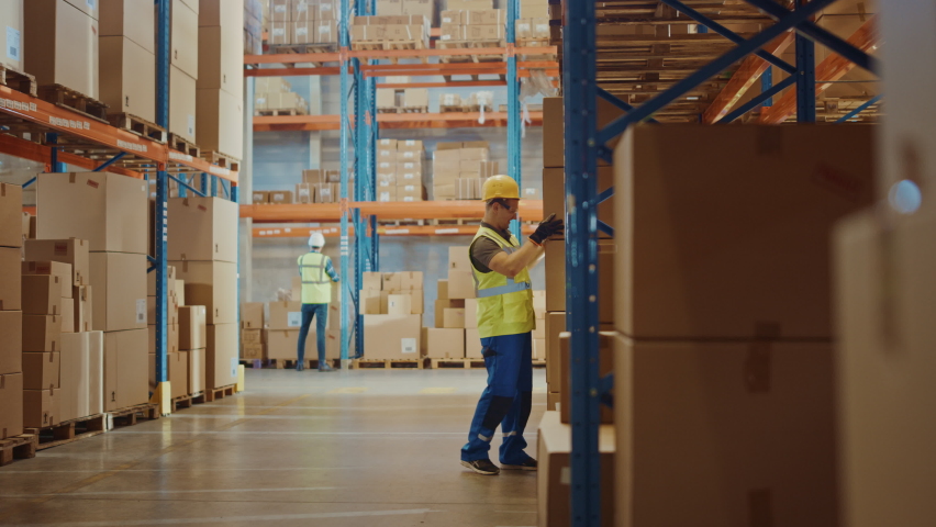 Warehouse Worker Has Work Related Accident Falls while Trying to Pick Up Cardboard Box from the Shelf. Colleagues Call for Help and Medical Assistance. Injury at Work. Slow Motion | Shutterstock HD Video #1059197633