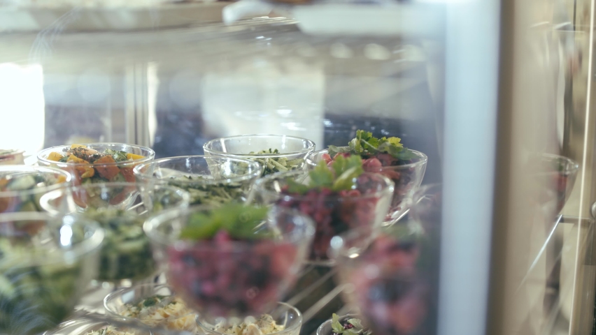 Students open a self-service food showcase and take salads in the school cafeteria. Close up. | Shutterstock HD Video #1059199334