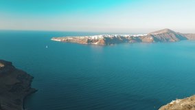 Aerial drone video of sandy beach blue sea water, clear blue sky island Cyclades, Santorini Greece