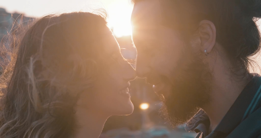Romantic young hipster couple's love time with beautiful sunlight, flare. Love, valentines and holiday concept. Kiss and hug. Royalty-Free Stock Footage #1059204140