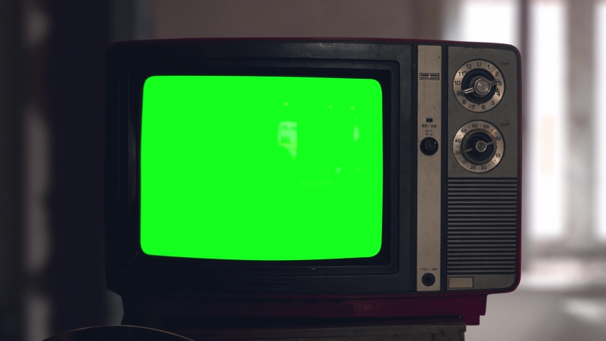 Switch on tuning an old tube vintage TV set than switch off. Wooden style retro Tv set with switchers. Old Fashioned TV Turns On. Green screen chromakey. Reflections on screen