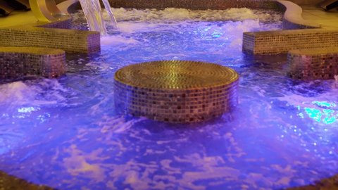 Warm water in a jacuzzi pool in a resort luxury hotel . Strong water pressure in the spa salon . Jacuzzi spa at wellness center . Hydroterrapy . Shot on ARRI ALEXA Cinema camera