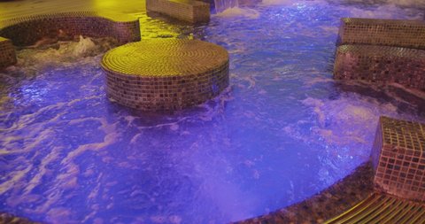 Warm water in a jacuzzi pool in a resort luxury hotel . Strong water pressure in the spa salon . Jacuzzi spa at wellness center . Hydroterrapy . Shot on ARRI ALEXA Cinema camera