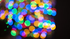 Blurred and glowing Christmas lights decoration at night in HD VIDEO. Out of focus abstract circular bokeh.